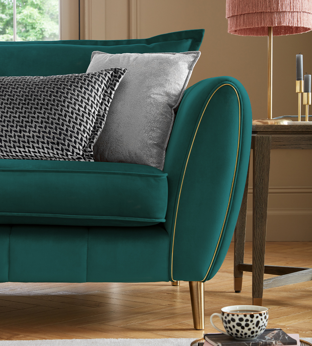 Green sofa with gold piping